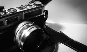 black and silver camera on white table